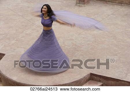 young woman in sari, dancing on patio View Large Photo Image Stock Image - young woman in sari, dancing on patio. Fotosearch