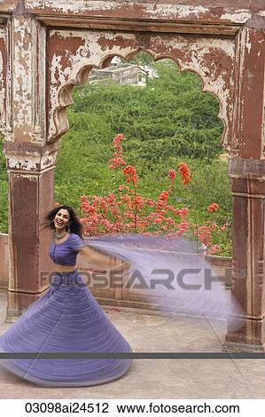 young woman in sari, dancing on terrace View Large Photo Image Stock Image - young woman in sari, dancing on terrace. Fotosearch