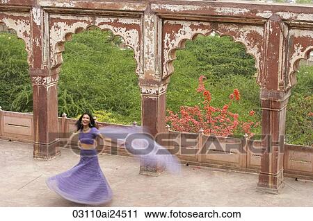 young woman in sari, dancing on terrace View Large Photo Image Stock Image - young woman in sari, dancing on terrace. Fotosearch