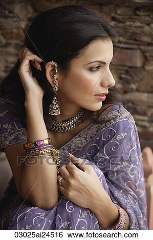 young woman in sari, hand on hair View Large Photo Image Stock Photograph - young woman in sari, hand on hair. Fotosearch