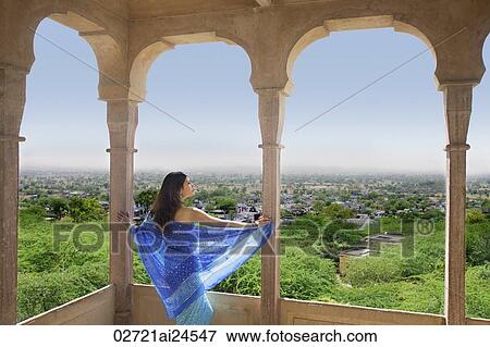 young woman in sari look out from terrace balcony View Large Photo Image Stock Photo - young woman in sari look out from terrace balcony. Fotosearch