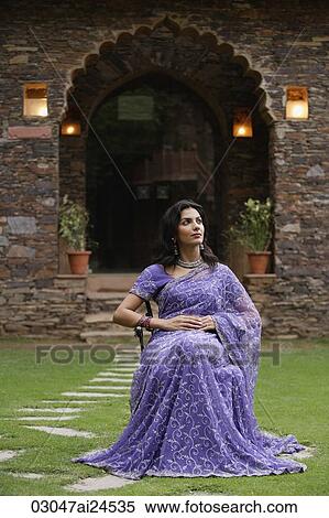 young woman in sari sitting in garden, portrait View Large Photo Image Stock Photography - young woman in sari sitting in garden, portrait. Fotosearch