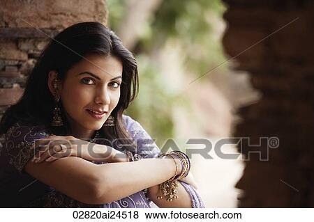 young woman in sari, sitting with arms folded View Large Photo Image Stock Photo - young woman in sari, sitting with arms folded. Fotosearch