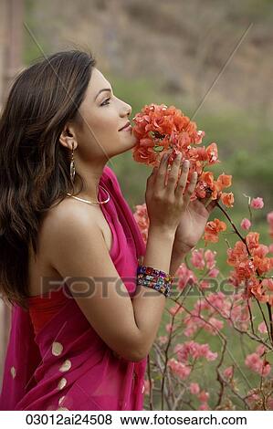 young woman in sari, smelling flowers View Large Photo Image Stock Photo - young woman in sari, smelling flowers. Fotosearch