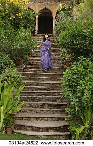 young woman in sari walking down the stairs View Large Photo Image Stock Image - young woman in sari walking down the stairs. Fotosearch