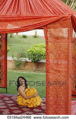 young woman in yellow sari, sitting in red tent View Large Photo Image Stock Photograph - young woman in yellow sari, sitting in red tent. Fotosearch