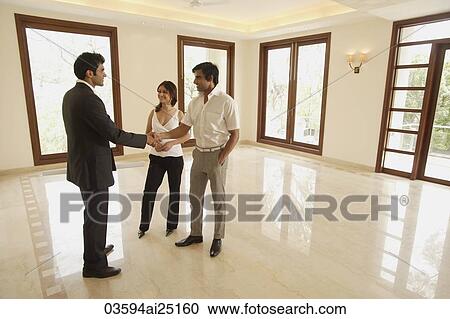 Stock Image - agent with young couple. Fotosearch