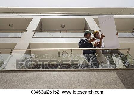 Architects looking at plans View Large Photo Image Stock Image - Architects looking at plans. Fotosearch