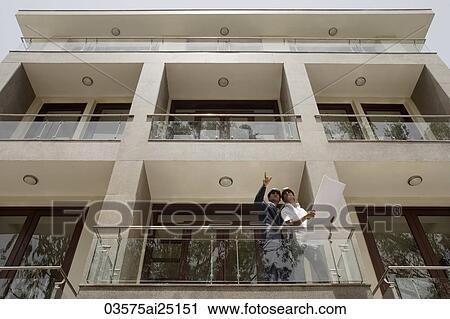 Stock Image - architects looking at plans. Fotosearch