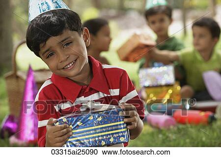 Stock Image - birthday boy with present. Fotosearch