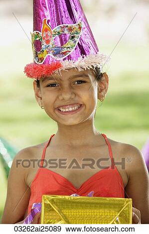 Stock Photo - birthday girl with present. Fotosearch