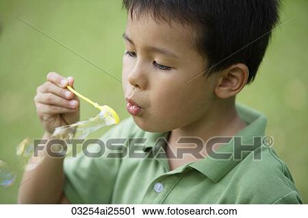 Boy blowing bubbles View Large Photo Image Stock Image - Boy blowing bubbles. Fotosearch