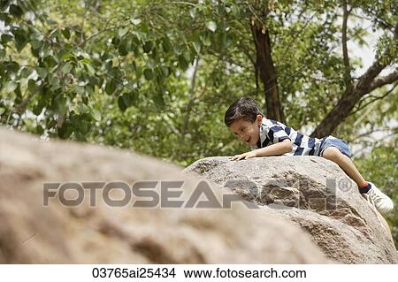 boy climbing on rocks View Large Photo Image Picture - boy climbing on rocks. Fotosearch