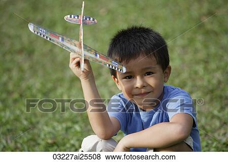 boy holding toy airplane View Large Photo Image Stock Photo - boy holding toy airplane. Fotosearch