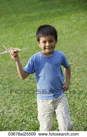 Stock Photo - boy holding toy airplane. Fotosearch