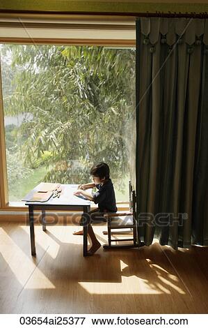 Stock Photo - boy playing at table. Fotosearch