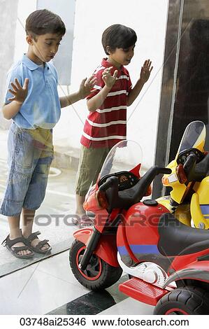 boys looking at toy motorcycles through the shop window View Large Photo Image Stock Photograph - boys looking at toy motorcycles through the shop window. Fotosearch