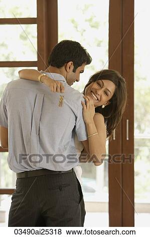 Stock Photo - couple embraced, woman with set of keys. Fotosearch