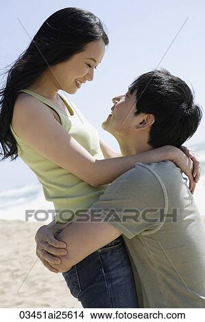 Couple embracing on beach View Large Photo Image Picture - Couple embracing on beach. Fotosearch