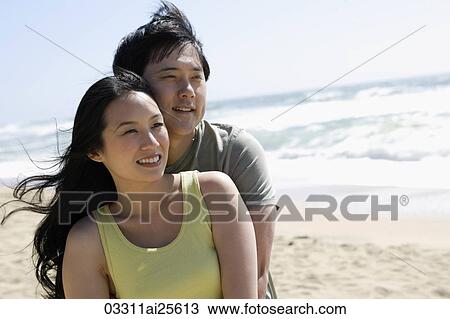 Couple embracing on beach View Large Photo Image Stock Image - Couple embracing on beach. Fotosearch