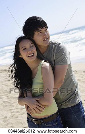 Couple embracing on beach View Large Photo Image Stock Image - Couple embracing on beach. Fotosearch