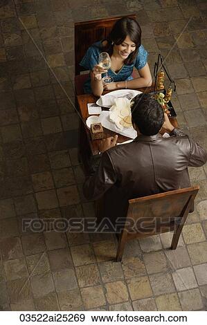 Stock Photo - couple enjoying meal and drinks. Fotosearch