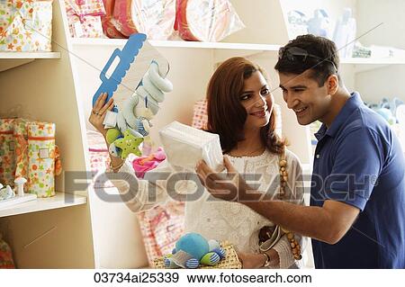 couple looking at baby items View Large Photo Image Stock Photo - couple looking at baby items. Fotosearch