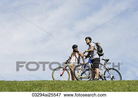 Couple on a bicycle ride View Large Photo Image Stock Photo - Couple on a bicycle ride. Fotosearch