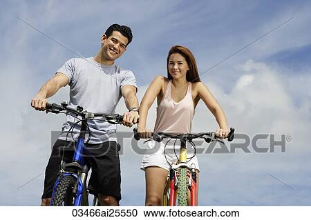 Couple on bicycles View Large Photo Image Stock Image - Couple on bicycles. Fotosearch