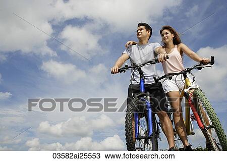 Stock Image - Couple on bicycles. Fotosearch