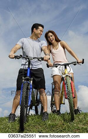 Couple on bicycles View Large Photo Image Stock Image - Couple on bicycles. Fotosearch