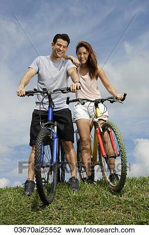 Couple on bicycles View Large Photo Image Stock Image - Couple on bicycles. Fotosearch