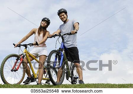 Couple on bicycles View Large Photo Image Stock Photo - Couple on bicycles. Fotosearch
