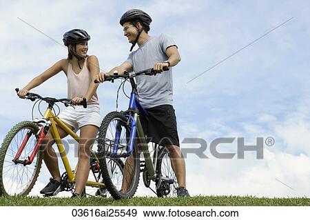 Couple on bicycles View Large Photo Image Stock Photo - Couple on bicycles. Fotosearch
