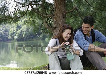 couple resting under tree View Large Photo Image Stock Photo - couple resting under tree. Fotosearch