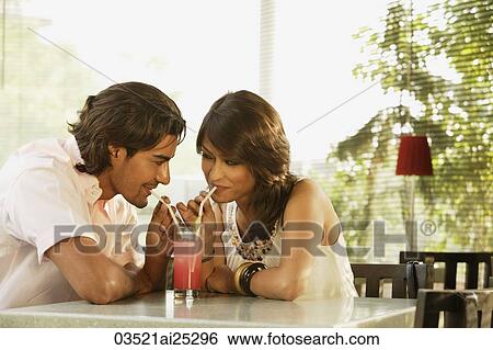 Stock Photograph - couple sharing drink. Fotosearch
