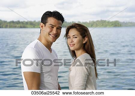 Couple standing near lake View Large Photo Image Stock Image - Couple standing near lake. Fotosearch