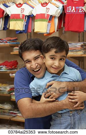 Stock Image - father and son in shop. Fotosearch