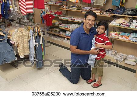 Stock Image - father and son shopping for clothes. Fotosearch