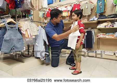 Stock Photography - father and son shopping for clothes. Fotosearch