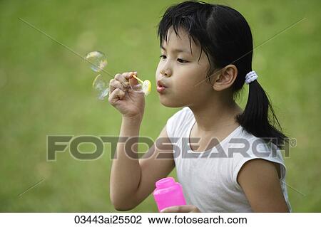 Girl blowing bubbles View Large Photo Image Stock Image - Girl blowing bubbles. Fotosearch