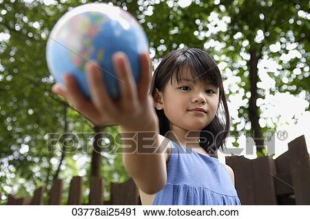Girl holding out globe View Large Photo Image Stock Image - Girl holding out globe. Fotosearch