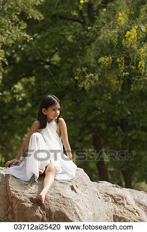 girl in white sari, sitting on rock View Large Photo Image Stock Image - girl in white sari, sitting on rock. Fotosearch