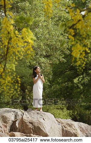 girl in white sari, standing in yoga pose on rock View Large Photo Image Stock Photo - girl in white sari, standing in yoga pose on rock. Fotosearch
