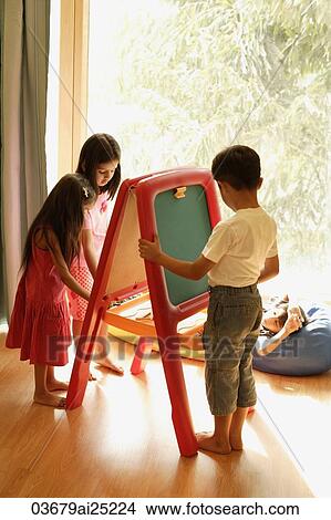 kids playing at easel View Large Photo Image Picture - kids playing at easel. Fotosearch