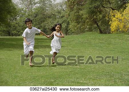 kids running in park, holding hands View Large Photo Image Stock Image - kids running in park, holding hands. Fotosearch