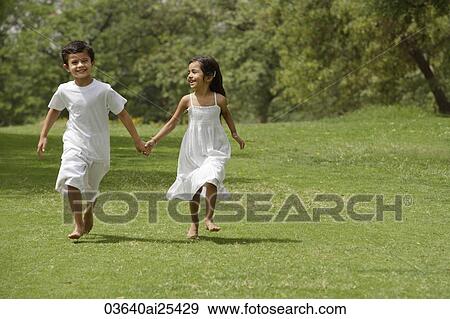 Stock Photo - kids running in park, holding hands. Fotosearch