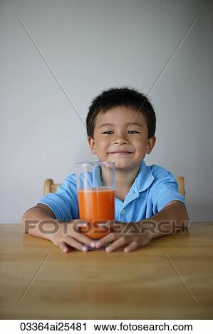 Little boy holding glass of juice View Large Photo Image Stock Image - Little boy holding glass of juice. Fotosearch