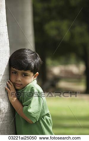 Little boy hugging tree trunk View Large Photo Image Stock Image - Little boy hugging tree trunk. Fotosearch