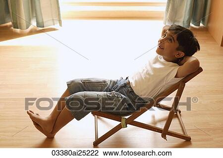 Stock Image - little boy in chair. Fotosearch